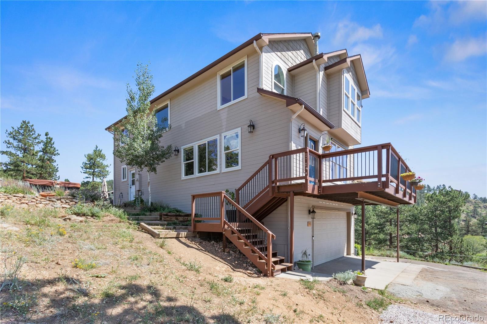 3345 Russell Gulch Road, Unit A Evergreen, CO 80439 - Photo 4 of 34 a view of a house with a yard