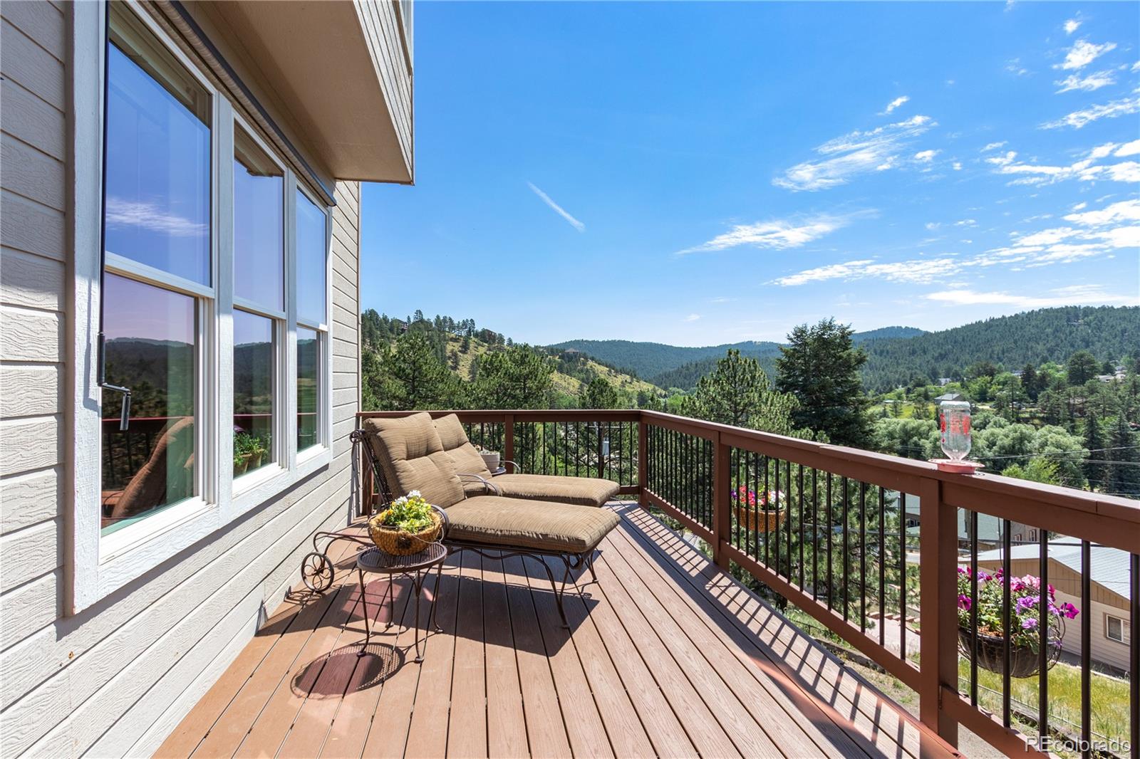 3345 Russell Gulch Road, Unit A Evergreen, CO 80439 - Photo 5 of 34 a view of balcony with couch and wooden floor