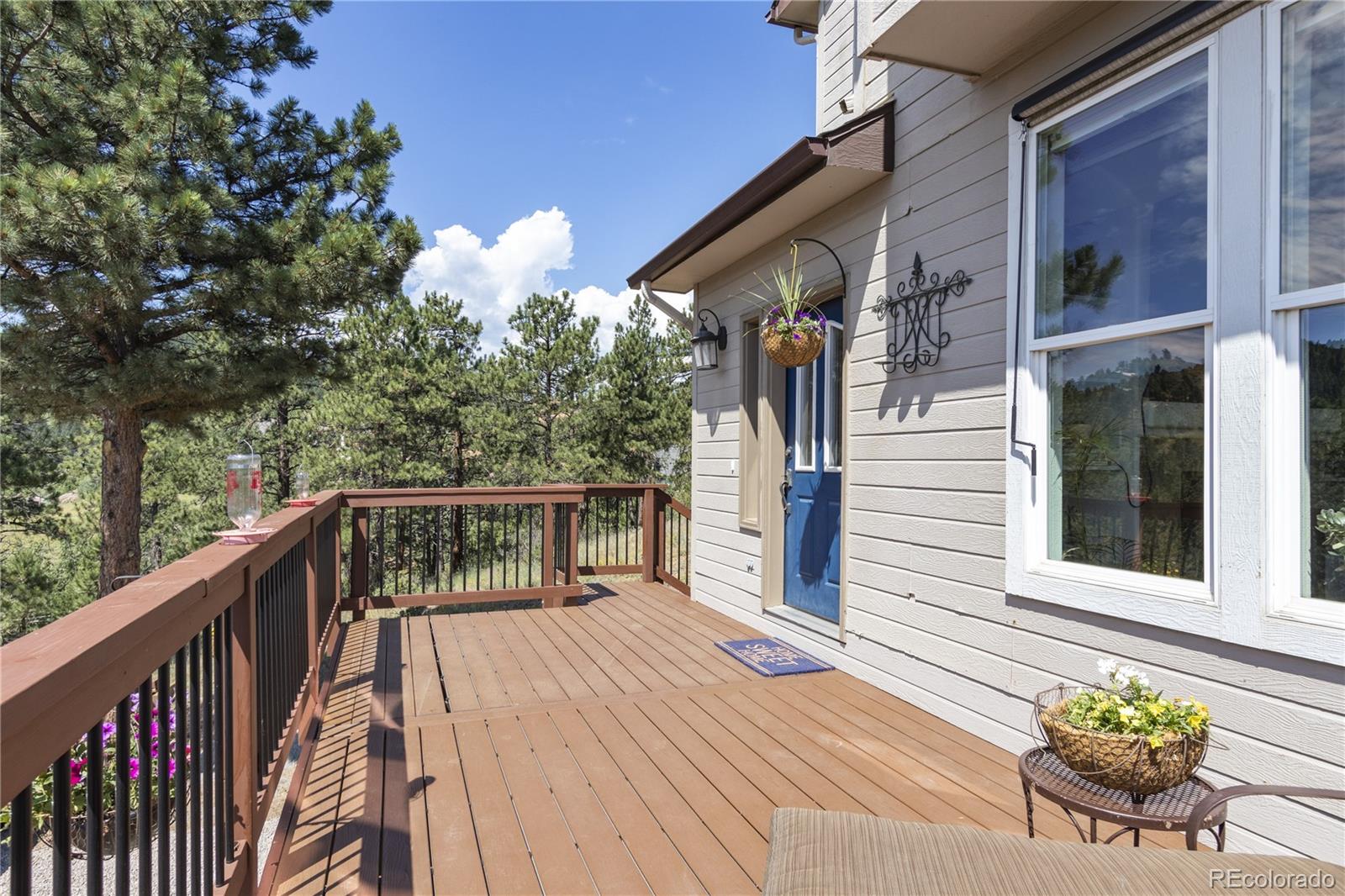3345 Russell Gulch Road, Unit A Evergreen, CO 80439 - Photo 6 of 34 a balcony with view of potted plants with wooden floor and fence