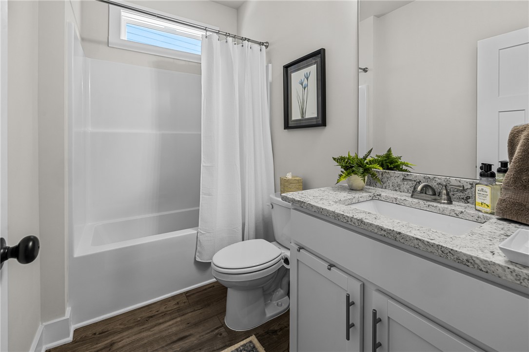 135 Bowers Estates Road Hartwell, GA 30643 - Photo 24 of 35 This bright bathroom features a spacious tub and a vanity with granite countertops.