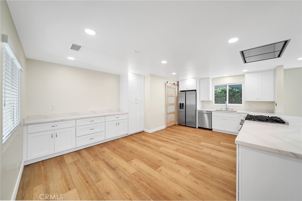 25251 Tuna Drive Dana Point, CA 92629 - Photo 13 of 30 a kitchen with stainless steel appliances kitchen island granite countertop a refrigerator and a stove top oven