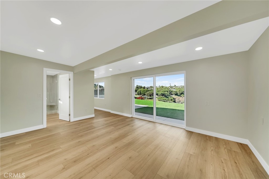 25251 Tuna Drive Dana Point, CA 92629 - Photo 14 of 30 a view of an empty room with wooden floor and a window