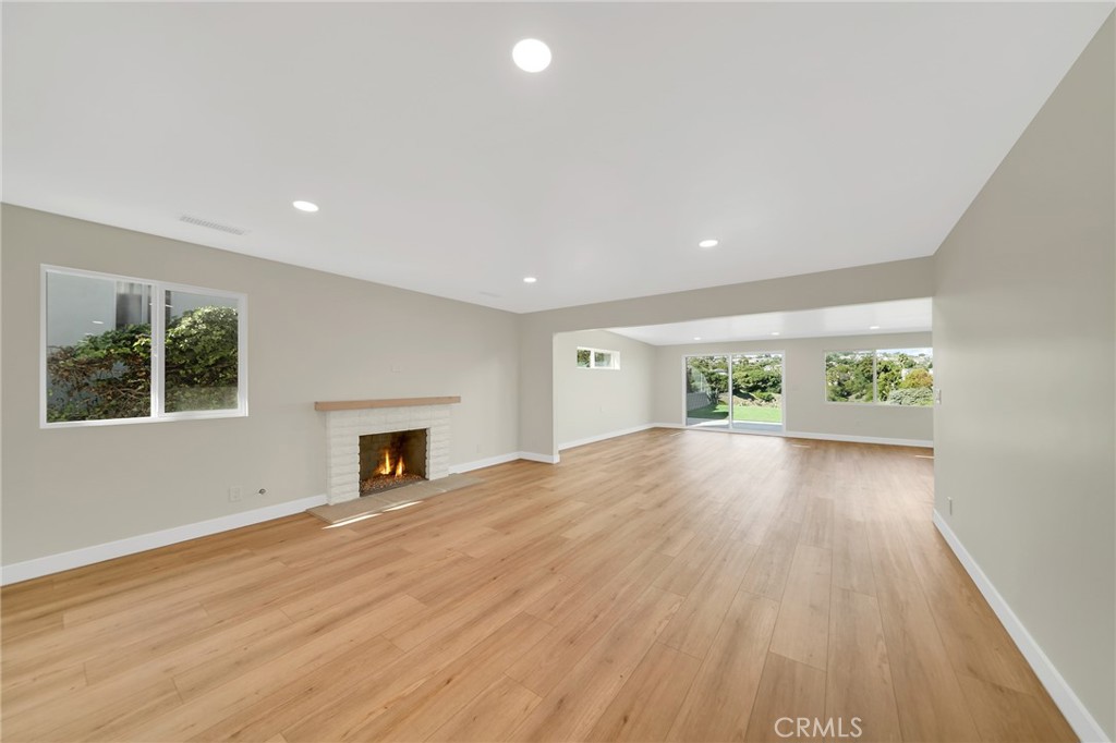 25251 Tuna Drive Dana Point, CA 92629 - Photo 3 of 30 a view of empty room with wooden floor and fireplace