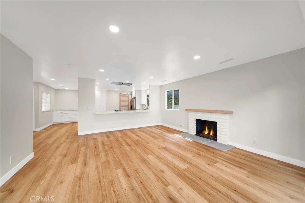 25251 Tuna Drive Dana Point, CA 92629 - Photo 4 of 30 a view of empty room with wooden floor and fireplace