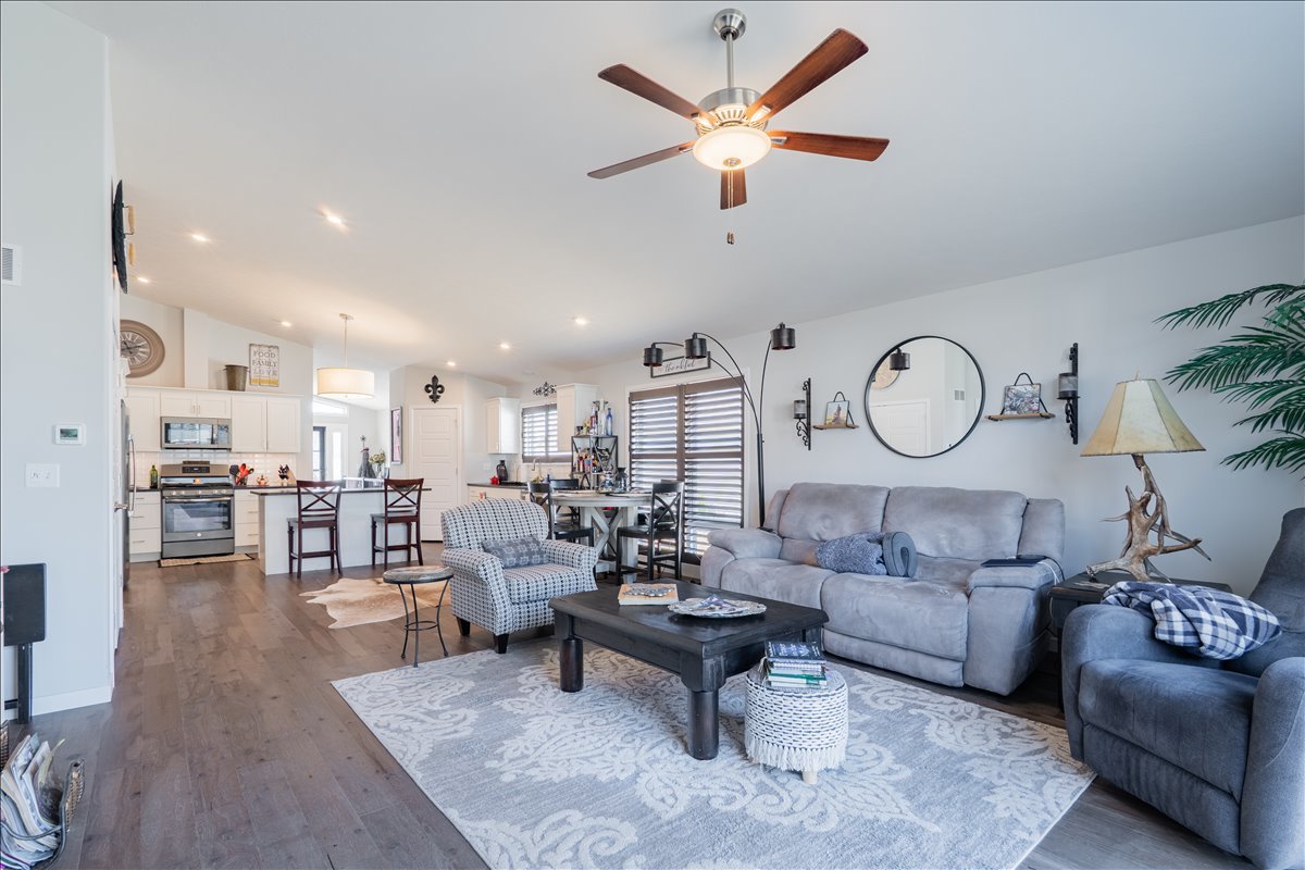 2618 Limestone Court Normal, IL 61761 - Photo 12 of 33 a living room with furniture a rug and a clock