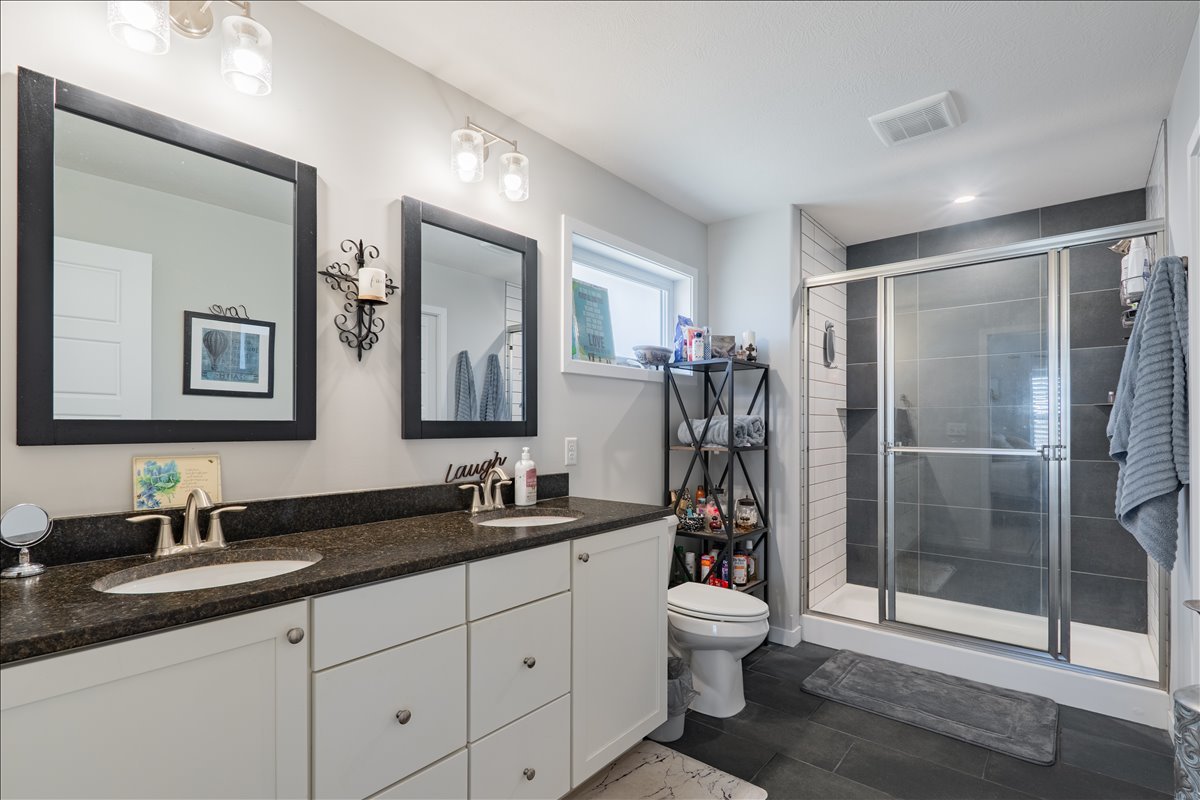 2618 Limestone Court Normal, IL 61761 - Photo 15 of 33 a bathroom with a double vanity sink toilet and shower