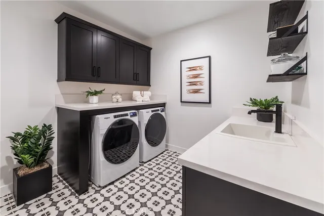 a utility room with sink dryer and washer