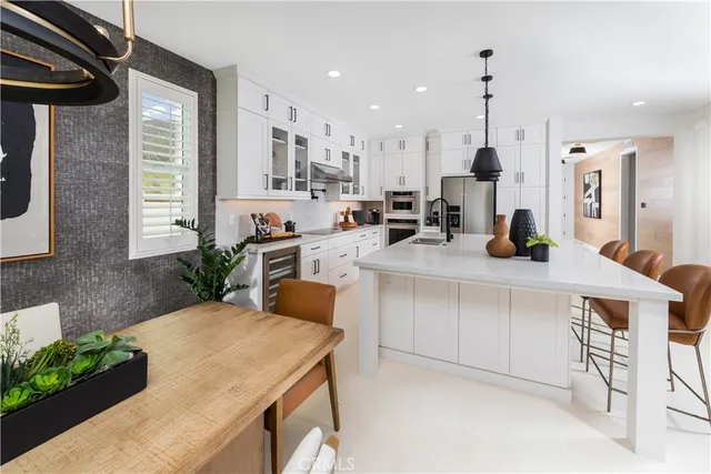a kitchen with counter space appliances and windows