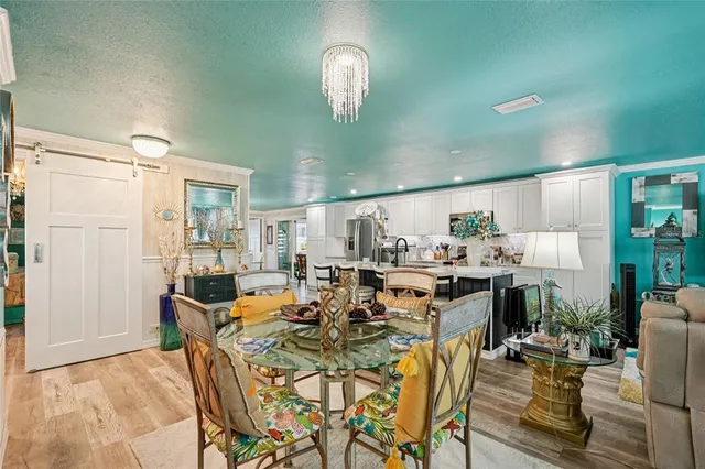 a view of a dining room with furniture and chandelier