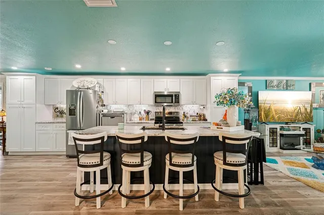 a kitchen with sink and chairs