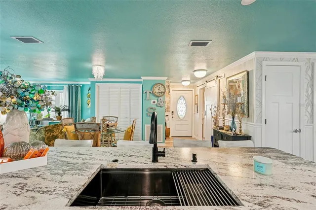 a kitchen with a sink and a refrigerator