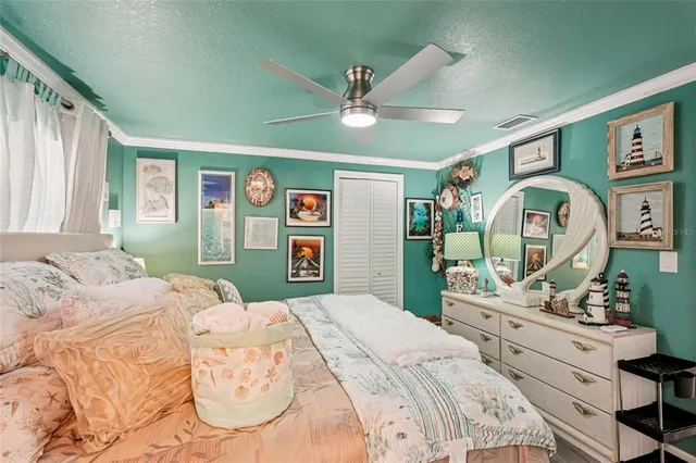 a bedroom with a large bed and a chandelier