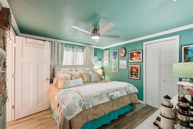 a bedroom with a bed and a chandelier