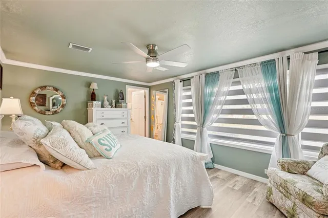 a bedroom with a large bed and a window