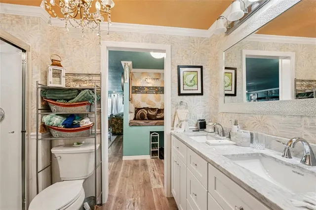 a bathroom with a sink a toilet and a mirror