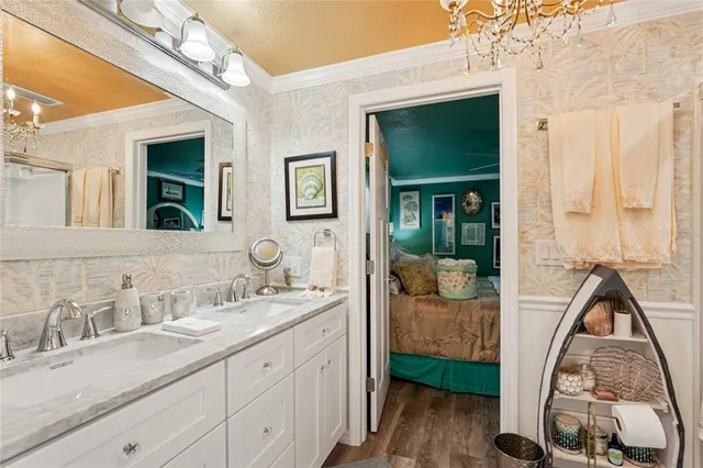 a en suite bathroom with a double vanity sink and a mirror