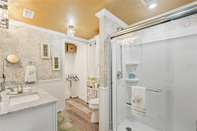 a bathroom with a granite countertop sink mirror and shower