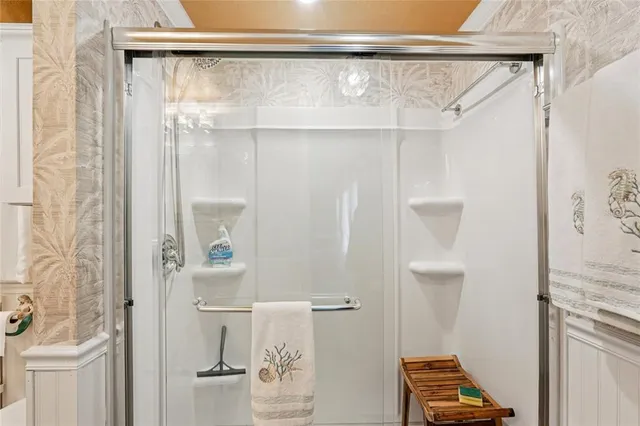 a bathroom with a shower and a sink