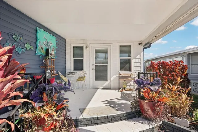 a very nice looking room with a large window and potted plants
