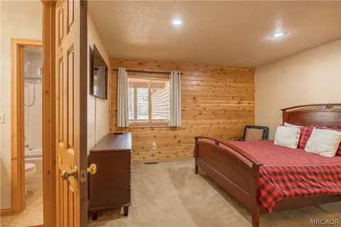 a bedroom with a bed and a night stand
