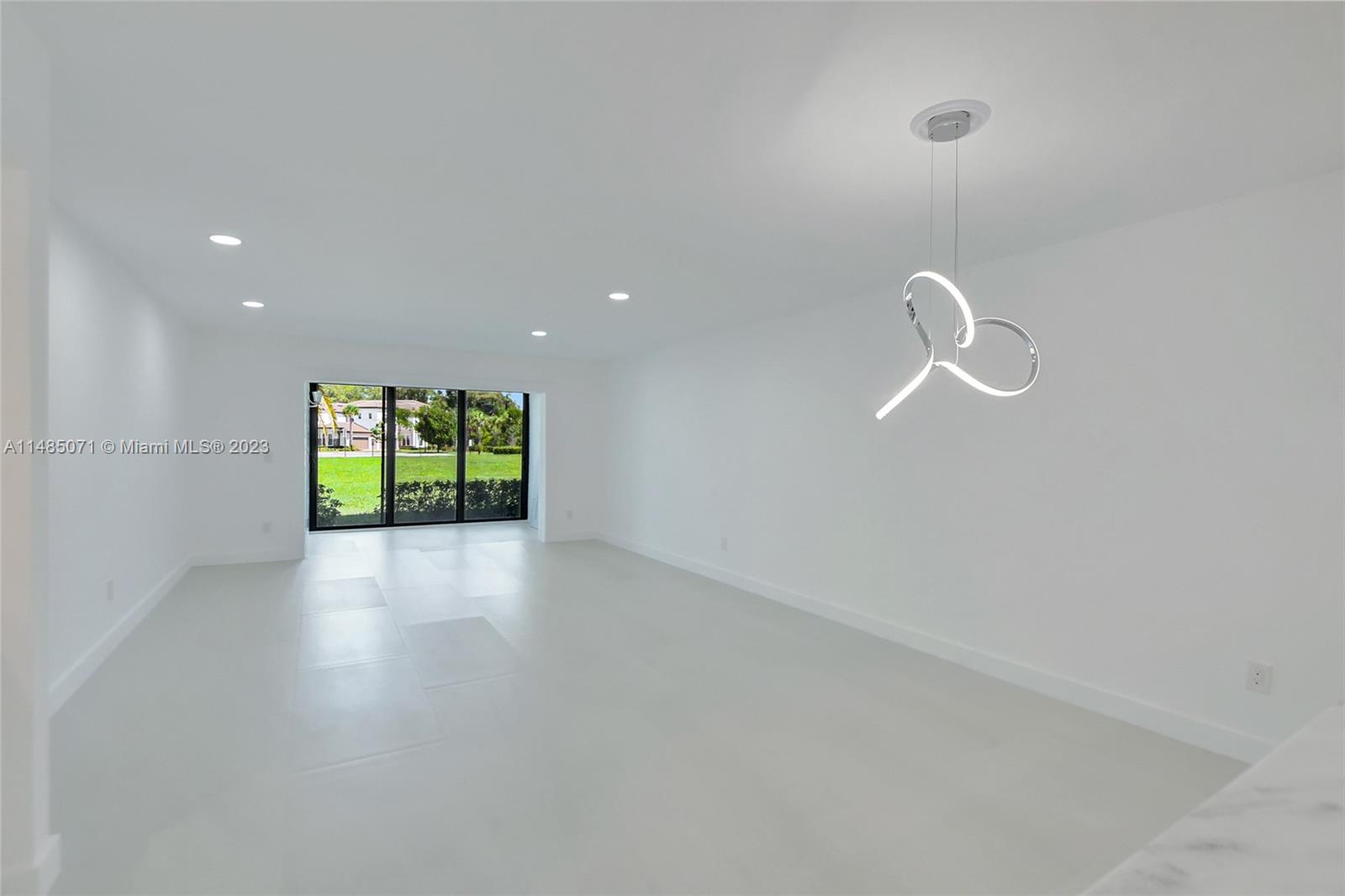 9264 Vista Del Lago, Unit E Boca Raton, FL 33428 - Photo 11 of 26 a view of room with window and wooden floor