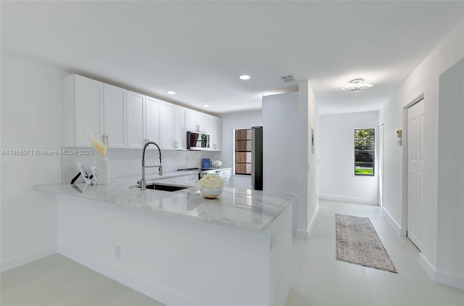 9264 Vista Del Lago, Unit E Boca Raton, FL 33428 - Photo 12 of 26 a kitchen with refrigerator and cabinets