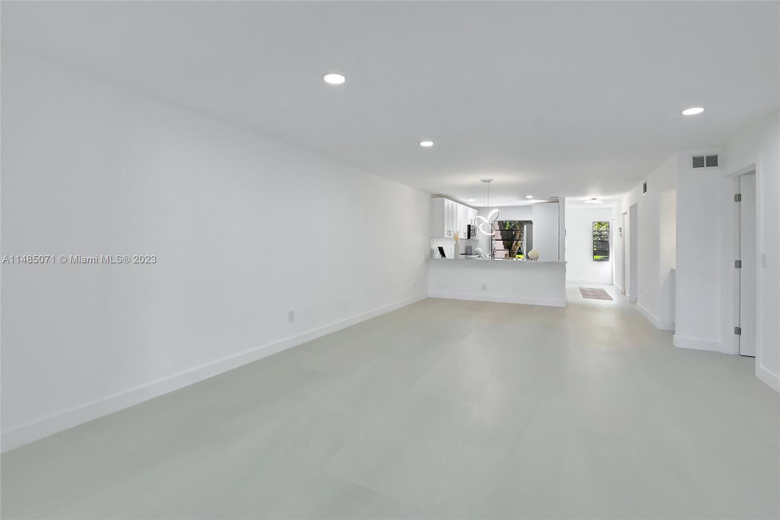 9264 Vista Del Lago, Unit E Boca Raton, FL 33428 - Photo 17 of 26 a view of a kitchen with a sink and a refrigerator