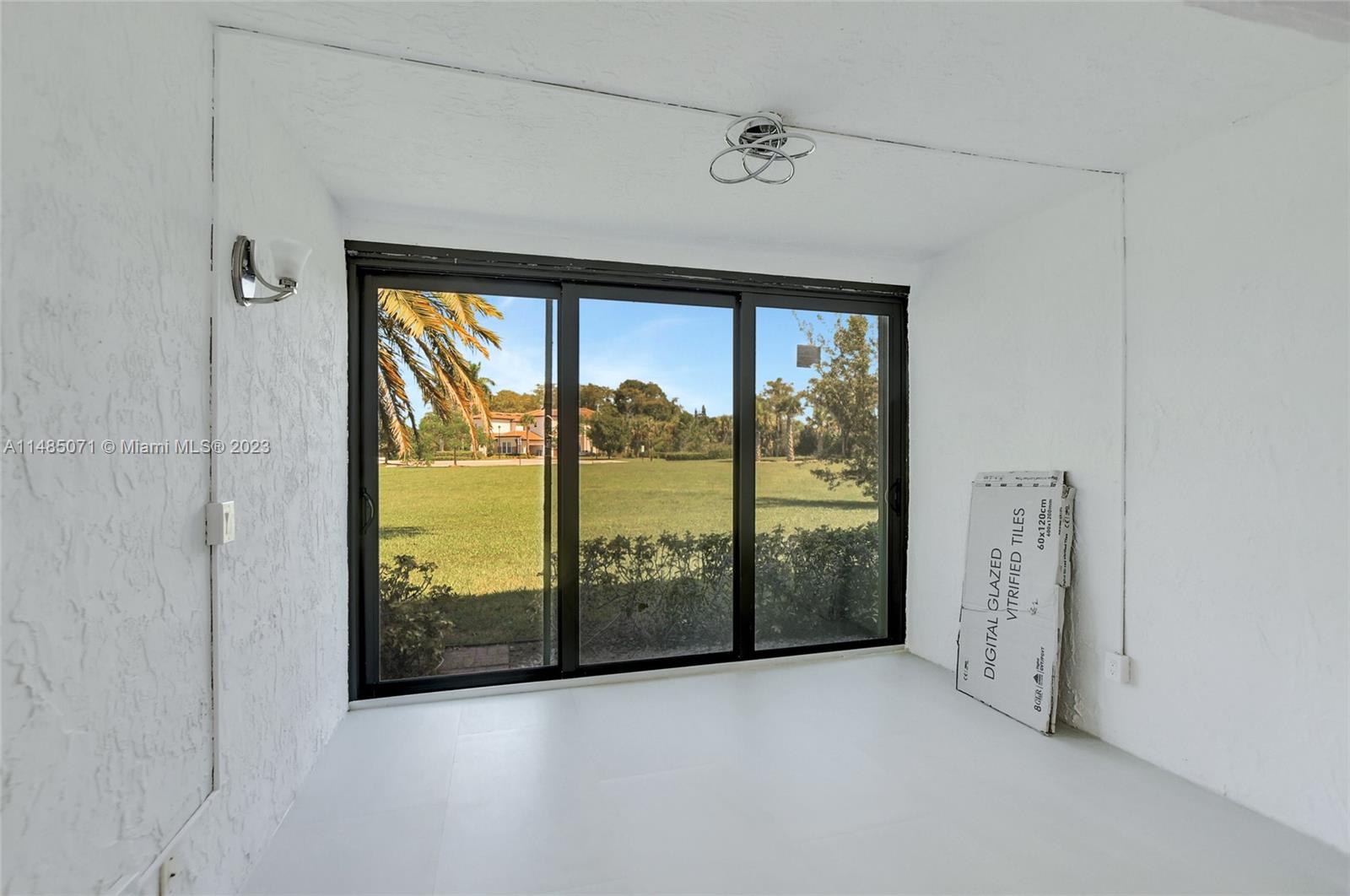 9264 Vista Del Lago, Unit E Boca Raton, FL 33428 - Photo 20 of 26 an empty room with sliding door and mountain view