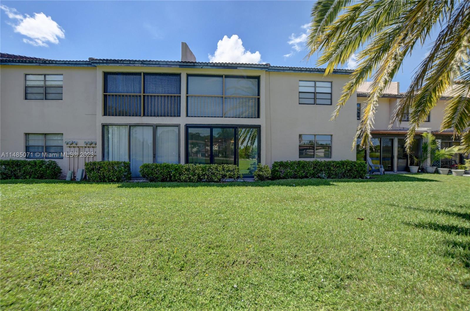 9264 Vista Del Lago, Unit E Boca Raton, FL 33428 - Photo 5 of 26 a front view of a house with garden
