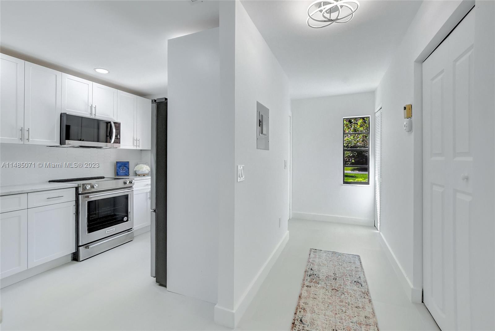 9264 Vista Del Lago, Unit E Boca Raton, FL 33428 - Photo 7 of 26 a kitchen with white cabinets and stainless steel appliances