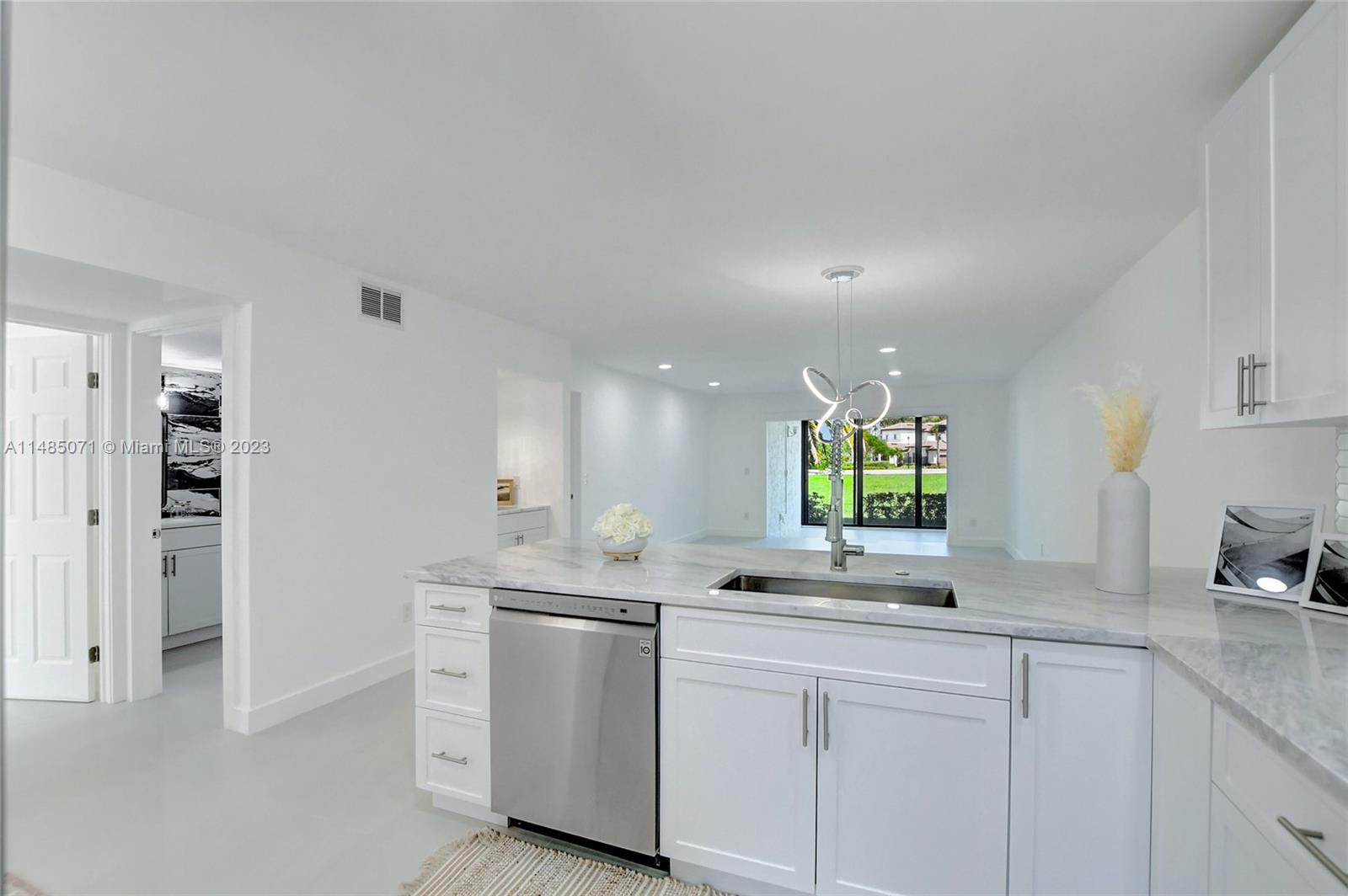 9264 Vista Del Lago, Unit E Boca Raton, FL 33428 - Photo 10 of 26 a kitchen with white cabinets and window