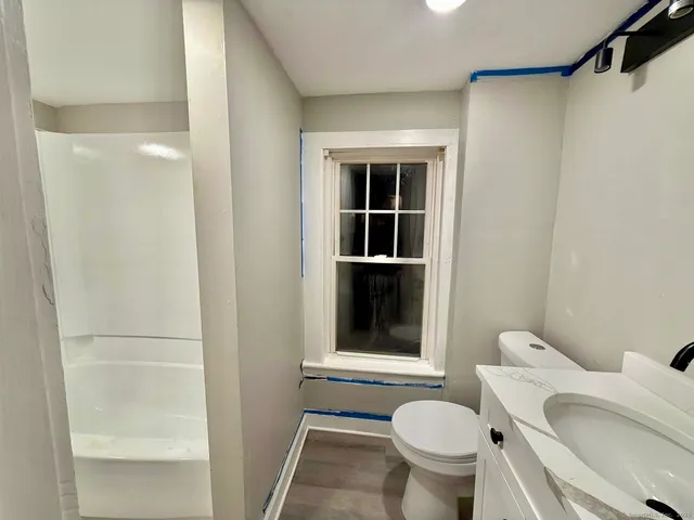 a bathroom with a toilet and a shower