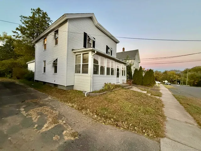 a view of a big house with a yard