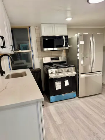 a kitchen with a refrigerator stove and a sink