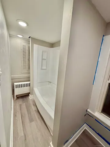 a bathroom with a bathtub a toilet and a sink