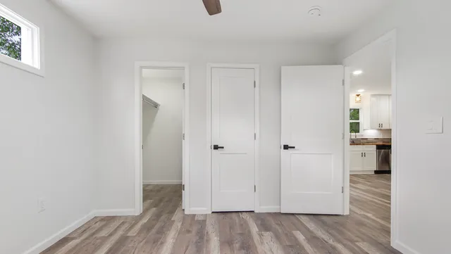 a view of a room with wooden floor cabinet and windows