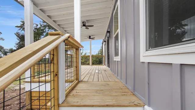 a view of a balcony with wooden floor and stairs