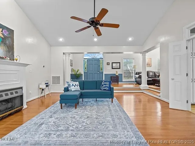 a living room with furniture and a fireplace