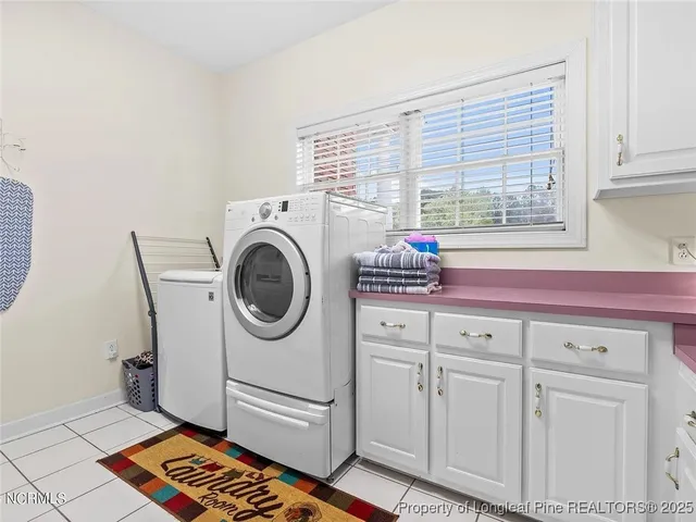 a utility room with sink dryer and washer