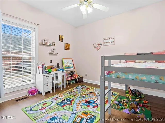 a bedroom with a bed and a desk in it