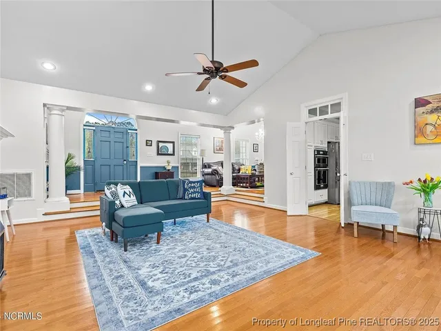 a living room with furniture and wooden floor