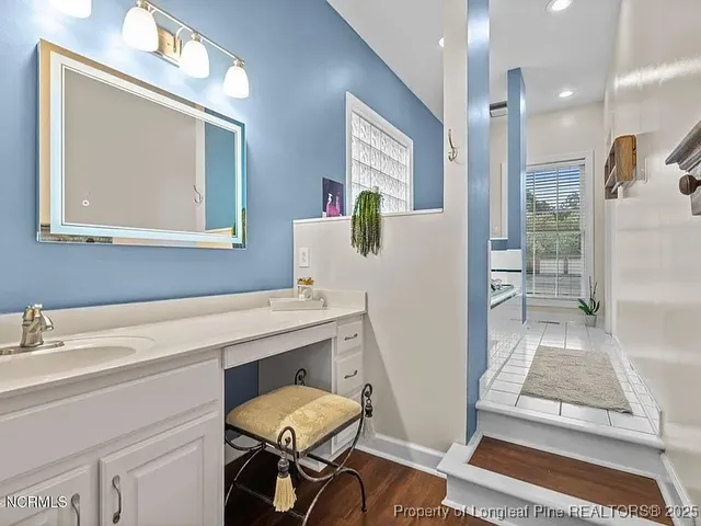 a bathroom with a sink mirror and a toilet