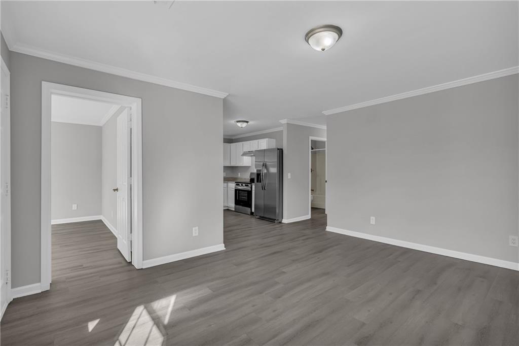 1040 Thomasville Estates Way Southeast Atlanta, GA 30315 - Photo 11 of 28 an empty room with wooden floor and closet