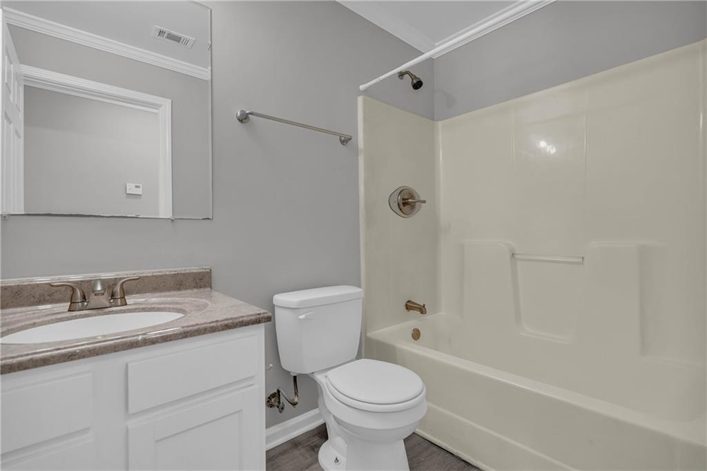 1040 Thomasville Estates Way Southeast Atlanta, GA 30315 - Photo 14 of 28 a bathroom with a sink toilet vanity and shower