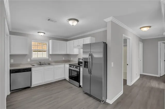 a kitchen with a sink stove and refrigerator
