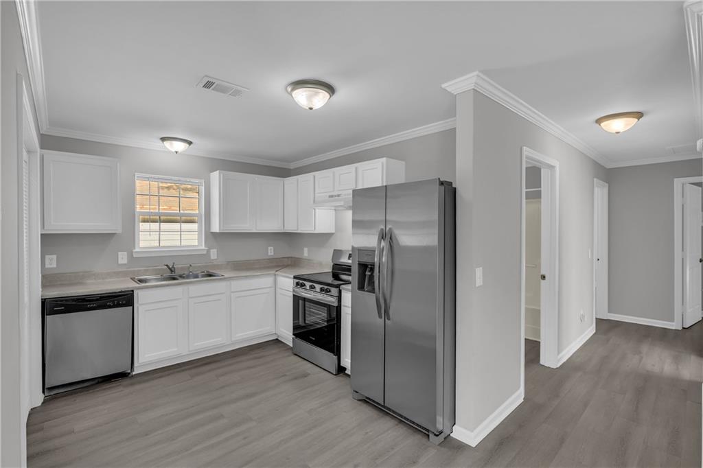 1040 Thomasville Estates Way Southeast Atlanta, GA 30315 - Photo 15 of 28 a kitchen with stainless steel appliances granite countertop a refrigerator and a stove top oven