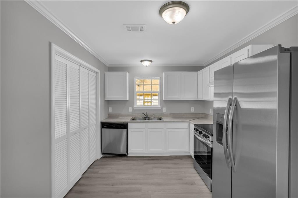 1040 Thomasville Estates Way Southeast Atlanta, GA 30315 - Photo 16 of 28 a kitchen with a sink stove and refrigerator