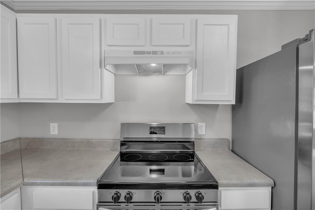 1040 Thomasville Estates Way Southeast Atlanta, GA 30315 - Photo 18 of 28 a stove top oven sitting inside of a kitchen