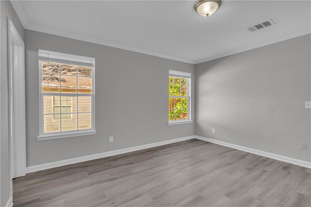 1040 Thomasville Estates Way Southeast Atlanta, GA 30315 - Photo 22 of 28 an empty room with a window and wooden floor