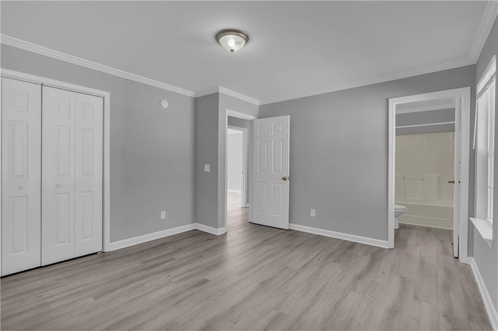 1040 Thomasville Estates Way Southeast Atlanta, GA 30315 - Photo 24 of 28 a view of an empty room with wooden floor